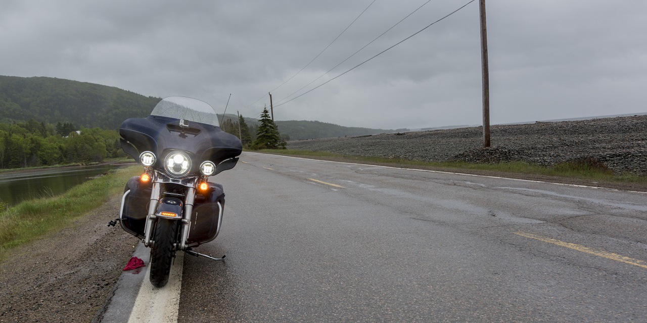 Motorcycle parked on side of the road needing transportation services