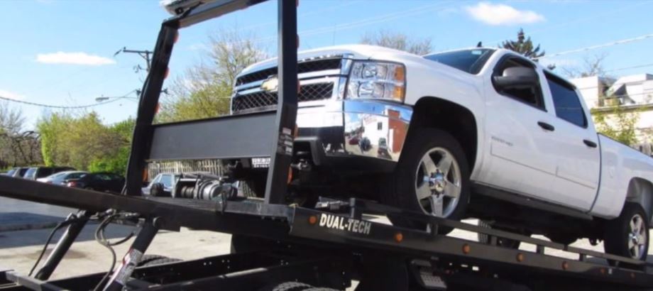 Flatbed Tow Truck Loading A White Pickup